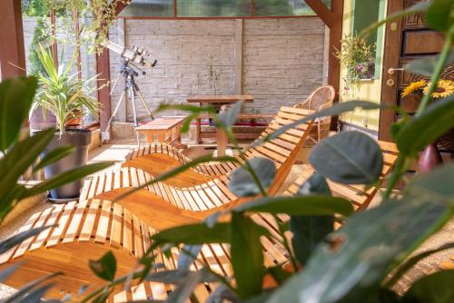 a patio with two chairs and a table and a table and a tripod at Šenk U Kovárny in Mariánské Lázně