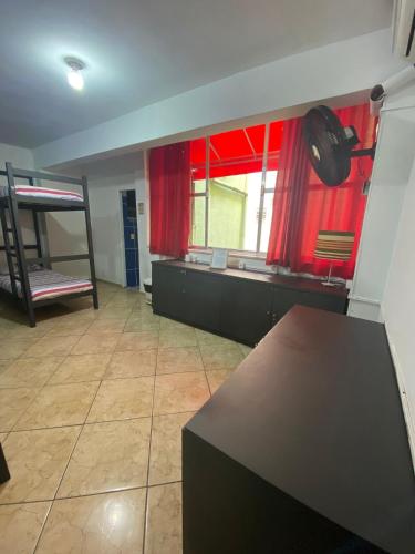 a room with a kitchen with a counter and a window at Ipanema Club Hostel in Rio de Janeiro