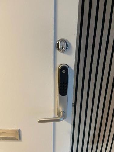 a door with a cell phone sticking out of it at Just Sleep Delux in Brande