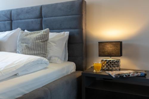 a hotel room with a bed and a table with a lamp at Aparthotel New Lux in Wrocław