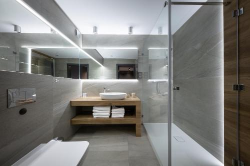 a bathroom with a sink and a shower at Aparthotel New Lux in Wrocław