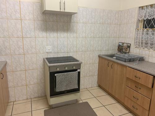 a kitchen with a stove and a sink at Seaview on Shelly in Margate