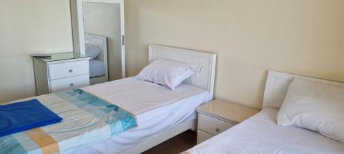 a small bedroom with two beds and a mirror at DREAM ISLAND Hotel in Luxor