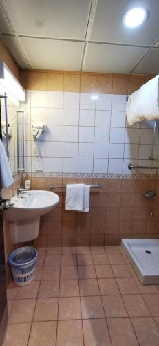 a bathroom with a sink and a toilet at Diyar Taiba Hotel in Medina