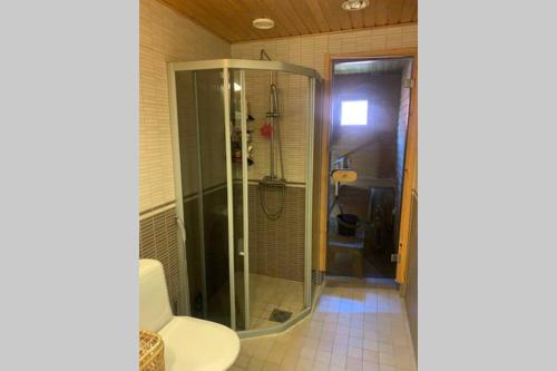 a bathroom with a shower and a toilet at Luxus house with Sauna Nearby Airport in Vantaa