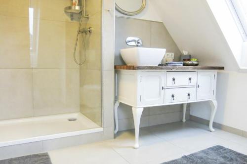 a white bathroom with a sink and a shower at Charmantes Studio in Schwabach bei Nürnberg (Messe) in Schwabach