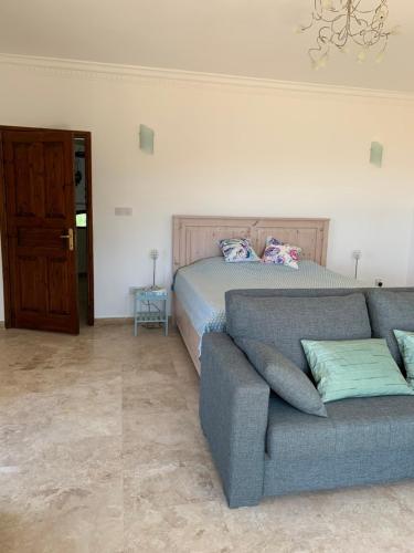 a living room with a couch and a bed at Spectacular views from this villa in Lapta in Kérynia