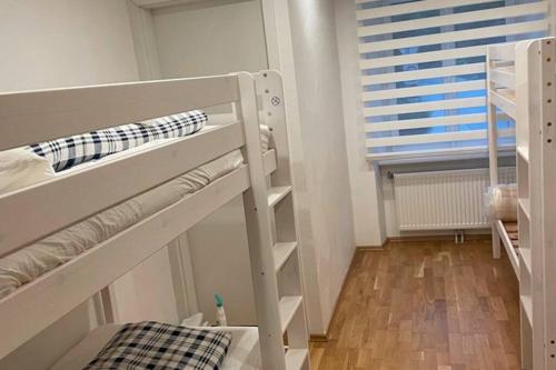 a small room with two bunk beds and a window at 76 m² Ferienwohnung 2 Schlafzimmer, max. 7 Gäste in Kennelbach