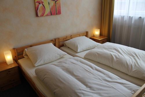 a bed in a room with a white bedspread at City Apartment Hotel Hamburg in Hamburg
