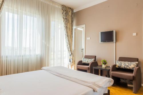 En eller flere senge i et værelse på Deluxe Cișmigiu Park