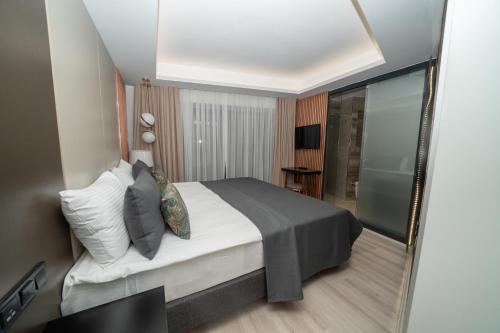 a bedroom with a bed and a mirror at Fama Karaköy in Istanbul