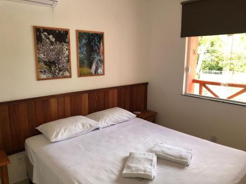 Uma cama ou camas num quarto em Ecoville das Mangueiras - Condomínio em Monte Gordo - Região de Guarajuba