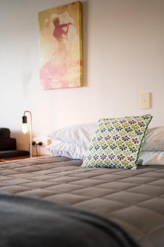 a bedroom with a bed with a pillow on it at Alexandra Heights Motel in Alexandra