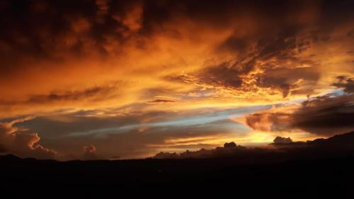 a view of a cloudy sky at sunset at Bella Vista Ranch Ecolodge in Turrialba