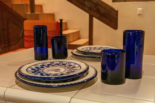 three blue and white plates and cups on a table at Hotel Casa Pereyra in Oaxaca City