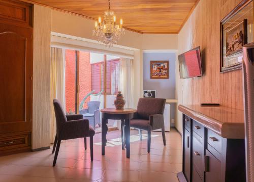 a kitchen with a table and chairs and a dining room at Hotel Casa Pereyra in Oaxaca City