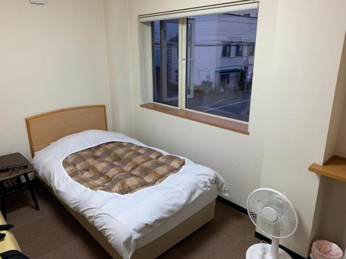 Postel nebo postele na pokoji v ubytování Ryokan Yamaichi