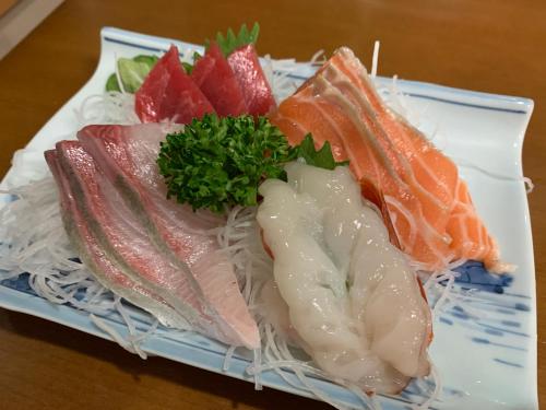 a plate of different types of fish and noodles at Ryokan Yamaichi in Wakkanai