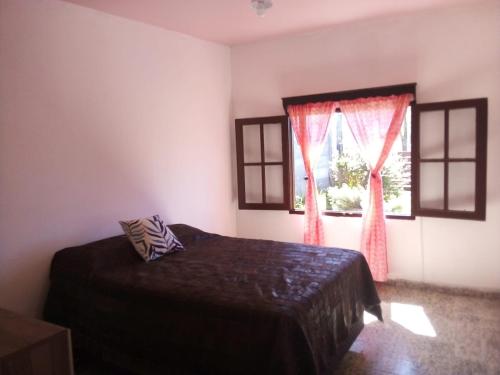 a bedroom with a bed and a window at Tákate in Costa Azul