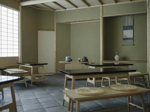 a classroom with tables and a chalkboard in a room at Portom International Hokkaido in Chitose