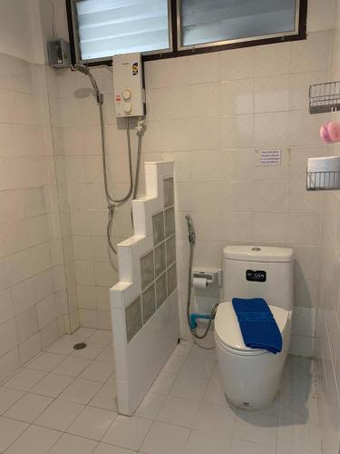 a bathroom with a toilet with a blue towel on it at Sunshine Guest House in Hua Hin