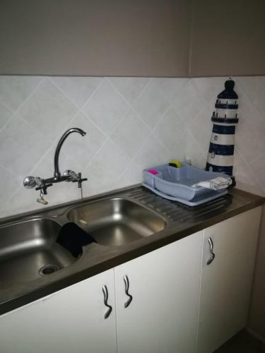 a kitchen counter with a sink and a faucet at Sarah's Place Guesthouse in Pretoria