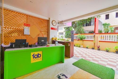 a fast food restaurant with a green counter at FabExpress Golden Leaf Airport in Pune