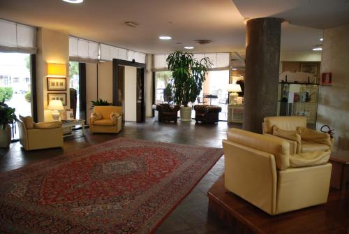 a living room with couches and a rug at Hotel Continental Brescia in Roncadelle