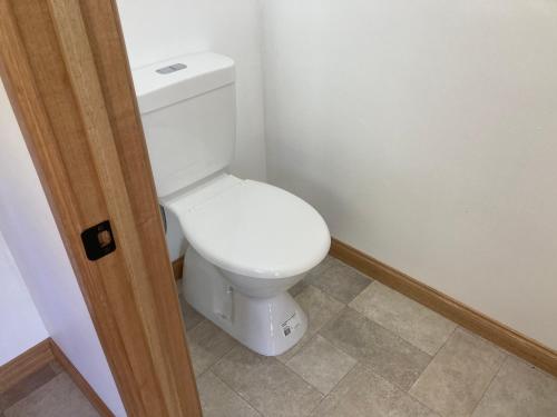 a bathroom with a white toilet in a room at Home Away From Home @ Lulworth in Lulworth