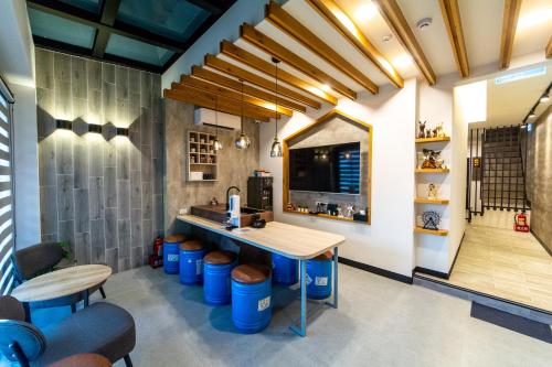 a kitchen with a counter with blue barrels in a room at W Cube in Tainan