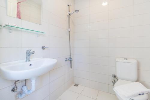 a white bathroom with a sink and a toilet at Apartments Near to City Center and Beach in Marmaris