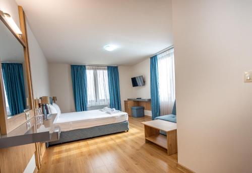 a hotel room with a bed and a mirror at Eco Hotel Momata in Kolarovo