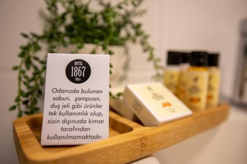 a sign on a wooden shelf with products on it at Urla 1867 Hotel in Urla