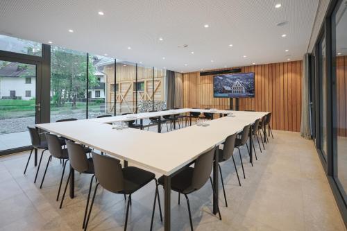 a large conference room with a long table and chairs at Triangel Boutique Hotel in Kranjska Gora