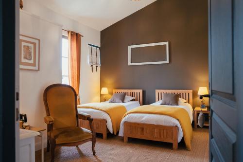 La Roche-ChalaisにあるVilla 2 Pas Sagesのベッドルーム1室(ベッド2台、椅子付)