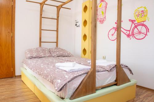 a bedroom with a bunk bed with a bike on the wall at Central Apartment Mountain View in Karlovo