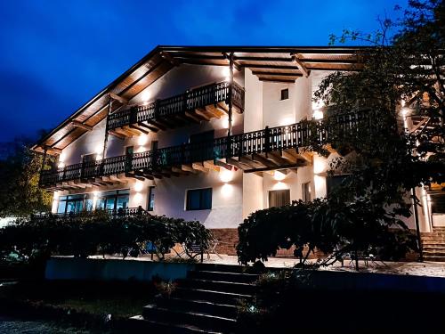 a large building with stairs in front of it at night at PANORAMIC Sus In Deal in Vişeu de Jos