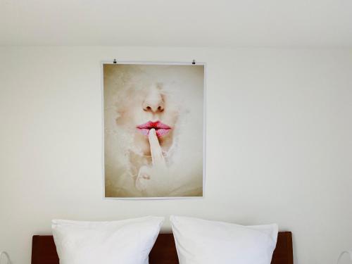a painting of a woman with a pink mustache at Ferienwohnung in Stockach am Bodensee in Stockach