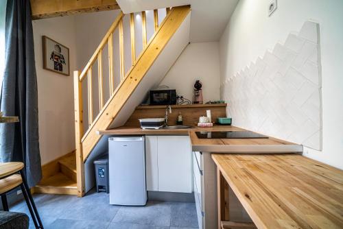 a small kitchen with a counter and a staircase at Le Pop'Art - Rent4night Grenoble in Grenoble