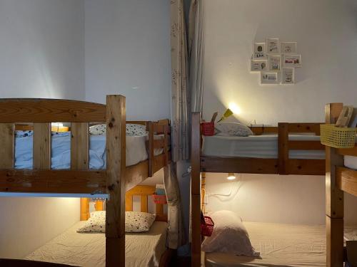 a bedroom with two bunk beds in a room at On My Way Dulan in Donghe