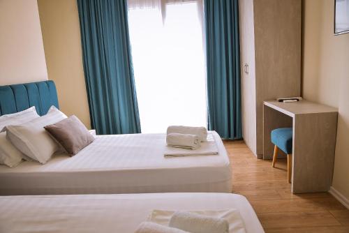 a hotel room with two beds and a window at Airport Garden Hotel in Rinas