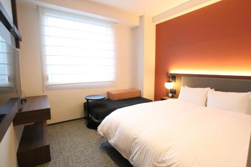 a hotel room with a bed and a window at Hotel The M's Kyoto in Kyoto