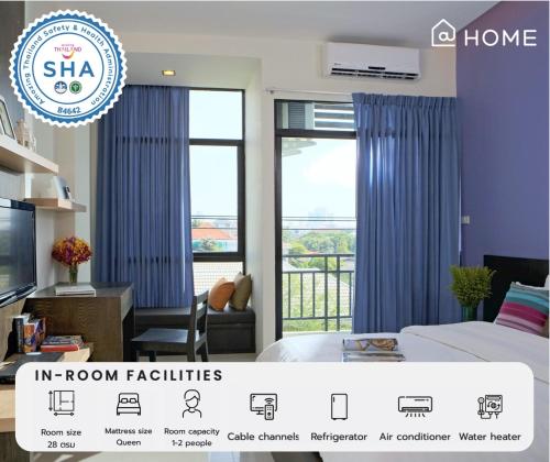 a room with blue curtains in a room facilities at @Home Residence in Bangkok