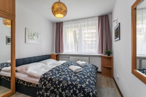 a small bedroom with a bed and a mirror at Rent like home - Żeromskiego 10 in Zakopane