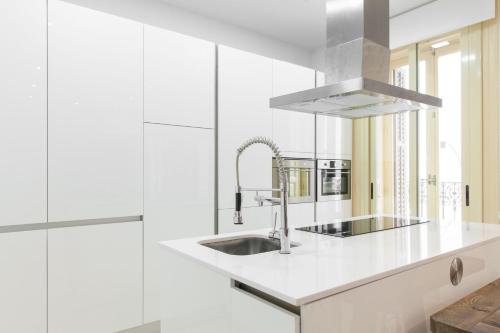 a white kitchen with a sink and a mirror at For You Rentals NEW Design Apartment Puerta del Sol PRE10C in Madrid