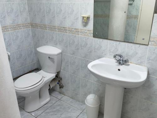 a bathroom with a toilet and a sink at Margate Boulevard 302 in Margate