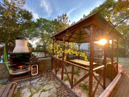 a gazebo with a fireplace in a yard at Мини-отель La Villa in Gelendzhik