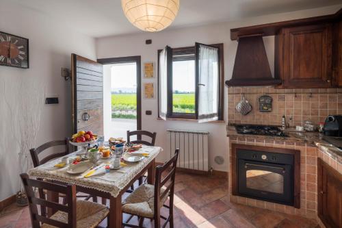 a dining room with a table and a fireplace at La Casa di Smilla - (Bevagna) in Foligno
