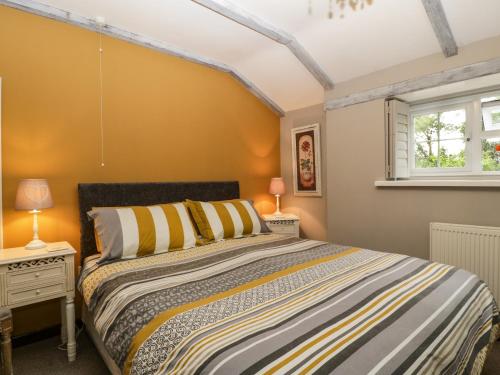 a bedroom with a bed and a window at Pear Tree Cottage in Mark
