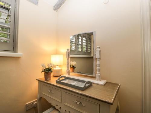 a dressing table with a mirror on top of it at Pear Tree Cottage in Mark